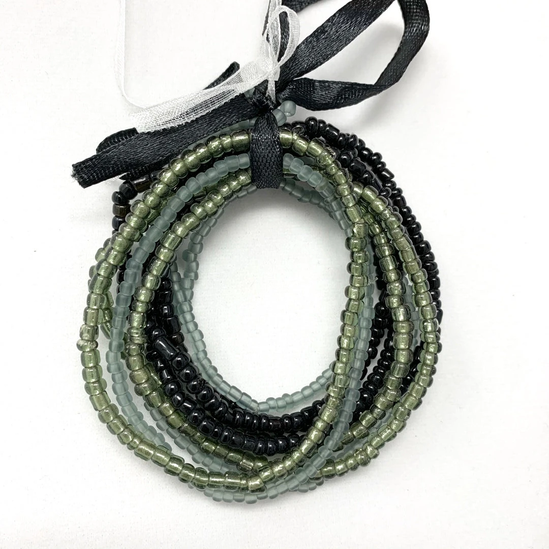 Mardi Gras Spot 7" Glass Bead Bracelets - Black And Grey (Dozen) Mardi Gras Spot 7" Glass Bead Bracelets - Black And Grey (Dozen)